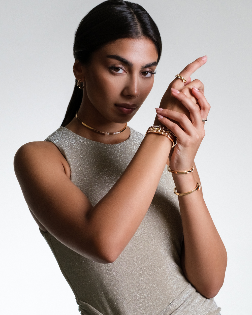 Model wearing Soit Belle Étoile diamond choker, bangles and rings in 18K gold
