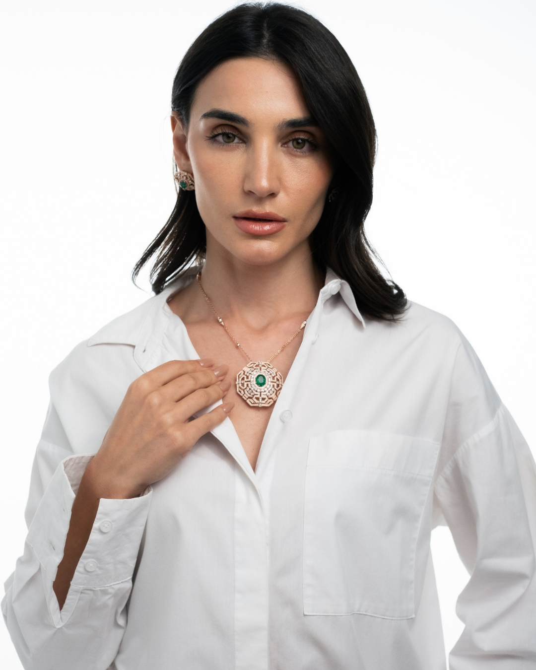 Model wearing Soit Belle Vista emerald and diamond pendant in 18K gold